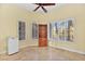 Bright bedroom with a ceiling fan, wood cabinet, and multiple windows at 255 El Camino Verde St, Henderson, NV 89074