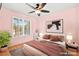 This light and airy bedroom features hardwood floors, a ceiling fan, and shuttered windows at 255 El Camino Verde St, Henderson, NV 89074