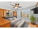 This bedroom offers built in storage, a ceiling fan, and a window with wooden shutter blinds at 255 El Camino Verde St, Henderson, NV 89074