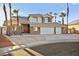 Inviting two-story home with desert landscaping, a three-car garage, and a tile roof at 255 El Camino Verde St, Henderson, NV 89074