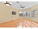 Bright living room features wood floors, a ceiling fan, and shuttered windows at 255 El Camino Verde St, Henderson, NV 89074