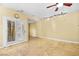 Open living room features French doors and a ceiling fan with unique track lighting at 255 El Camino Verde St, Henderson, NV 89074