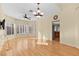 Sun-filled living room features wood floors, a ceiling fan, and many windows at 255 El Camino Verde St, Henderson, NV 89074