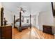 Spacious main bedroom featuring a four-poster bed, hardwood floors, and ample natural light at 255 El Camino Verde St, Henderson, NV 89074