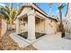 View of the pool house with neutral paint and pillars with a view of the surrounding landscaping at 255 El Camino Verde St, Henderson, NV 89074