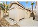 View of the pool house showing security shutters, a neutral paint scheme, and the roofline at 255 El Camino Verde St, Henderson, NV 89074