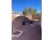 A backyard with a section paved with stone pavers, adorned with decorative flower pots at 2694 Hillgrass Rd, Las Vegas, NV 89123