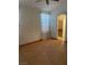 Neutral bedroom with wood floors, ceiling fan, and natural light from the window at 2694 Hillgrass Rd, Las Vegas, NV 89123