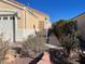 Side yard view of a single-story home with mature desert landscaping at 2694 Hillgrass Rd, Las Vegas, NV 89123