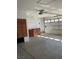 Well-lit garage featuring storage cabinets with louvered doors and an automatic door with a window panel at 2694 Hillgrass Rd, Las Vegas, NV 89123