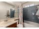 Compact bathroom featuring a single sink vanity, toilet, and shower-tub combination with nautical curtain at 2712 Rialto Rd, Las Vegas, NV 89108