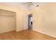 Bedroom with a ceiling fan and wood-look flooring with standard closet and neutral walls at 2712 Rialto Rd, Las Vegas, NV 89108