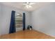 This bedroom has a ceiling fan, window and wood-look flooring at 2712 Rialto Rd, Las Vegas, NV 89108