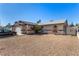 Single-story home featuring gravel landscaping, arched windows, and gated entry for added curb appeal at 2712 Rialto Rd, Las Vegas, NV 89108