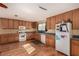 Functional kitchen with wood cabinets, undermount sink, and white appliances at 2712 Rialto Rd, Las Vegas, NV 89108