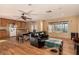 Open-concept living room with wood floors, ceiling fan, and view to the outside deck at 2712 Rialto Rd, Las Vegas, NV 89108