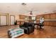 Open-concept living room and kitchen with wood flooring, ceiling fan, and plenty of natural light at 2712 Rialto Rd, Las Vegas, NV 89108