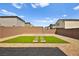 A backyard with grass, landscaping, brick pavers and a wall at 2724 High Echelon Rd, North Las Vegas, NV 89086