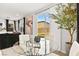 Cozy dining area with a glass table, view of the backyard, and access to outdoor space at 2724 High Echelon Rd, North Las Vegas, NV 89086