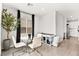 Bright dining area features a modern glass table, white chairs, and natural lighting at 2724 High Echelon Rd, North Las Vegas, NV 89086