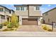 Two-story home featuring a brick driveway leading up to a two-car garage and stone accents at 2724 High Echelon Rd, North Las Vegas, NV 89086