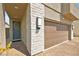 Front exterior showing stone accents, a two-car garage, brick driveway, and a welcoming front door with wreath at 2724 High Echelon Rd, North Las Vegas, NV 89086