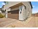 Modern home featuring a two-car garage, stone accents, and desert landscaping at 2724 High Echelon Rd, North Las Vegas, NV 89086