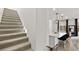 Staircase leading to the home's interior with a view of the modern kitchen and breakfast bar at 2724 High Echelon Rd, North Las Vegas, NV 89086