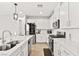 Contemporary kitchen with white cabinetry, stainless appliances, and island with sink at 2724 High Echelon Rd, North Las Vegas, NV 89086