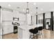 Bright kitchen featuring white cabinetry, stainless steel appliances, pendant lighting and a large island with seating at 2724 High Echelon Rd, North Las Vegas, NV 89086