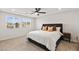 Spacious main bedroom featuring a tray ceiling, ceiling fan, and neutral carpeting at 2724 High Echelon Rd, North Las Vegas, NV 89086