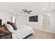 Bright main bedroom featuring plush carpet, a ceiling fan, television, and an ensuite bathroom with a glass shower at 2724 High Echelon Rd, North Las Vegas, NV 89086