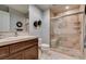 Elegant bathroom featuring a glass enclosed shower and a decorative vanity with marble countertops at 30 Via Mantova # 202, Henderson, NV 89011