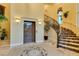 Grand foyer boasts mosaic tile flooring, an elevator, and a sweeping staircase with iron railing at 30 Via Mantova # 202, Henderson, NV 89011