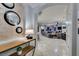 Inviting hallway leading to an open living area, showcasing travertine flooring and elegant decor at 30 Via Mantova # 202, Henderson, NV 89011