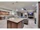 Open-concept living space with kitchen island, stainless steel appliances, and granite countertops at 30 Via Mantova # 202, Henderson, NV 89011