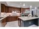 This kitchen features dark wood cabinets, granite countertops, and stainless steel appliances at 30 Via Mantova # 202, Henderson, NV 89011