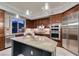 Beautiful kitchen featuring stainless steel appliances, rich wood cabinetry, and a granite island at 30 Via Mantova # 202, Henderson, NV 89011