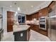 Beautiful kitchen featuring stainless steel appliances, rich wood cabinetry, and a granite island at 30 Via Mantova # 202, Henderson, NV 89011