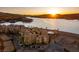 An aerial view of lakefront condominiums at sunset, with palm trees, and a pool at 30 Via Mantova # 202, Henderson, NV 89011