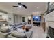 Well lit open living room featuring a modern ceiling fan, tile floors, fireplace, and wet bar at 30 Via Mantova # 202, Henderson, NV 89011