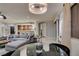 Spacious living room featuring a gray sofa, travertine tile floors, and an adjacent wet bar at 30 Via Mantova # 202, Henderson, NV 89011