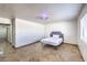 Cozy bedroom with tile flooring, neutral colors, and a view into the hallway at 3163 High View Dr, Henderson, NV 89014