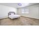 Simple bedroom with a cozy bed, tile floors, and natural light at 3163 High View Dr, Henderson, NV 89014