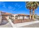 Charming single-story home featuring desert landscaping, a fountain, and a fenced front yard at 3163 High View Dr, Henderson, NV 89014