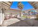 Cozy covered patio features string lights, comfortable seating, and a view of the front yard at 3163 High View Dr, Henderson, NV 89014