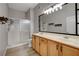 Bright bathroom featuring double sinks, large mirror, and a walk-in shower with modern fixtures at 3360 Cactus Shadow St # 102, Las Vegas, NV 89129