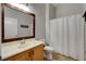 Updated bathroom featuring a wood framed mirror, shower and single sink vanity at 3360 Cactus Shadow St # 102, Las Vegas, NV 89129