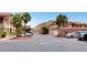 Well-maintained street view with palm trees, carports, and convenient parking spots in the complex at 3360 Cactus Shadow St # 102, Las Vegas, NV 89129