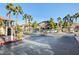 View of the gated entrance of the community, with palm trees and mature landscaping at 3360 Cactus Shadow St # 102, Las Vegas, NV 89129